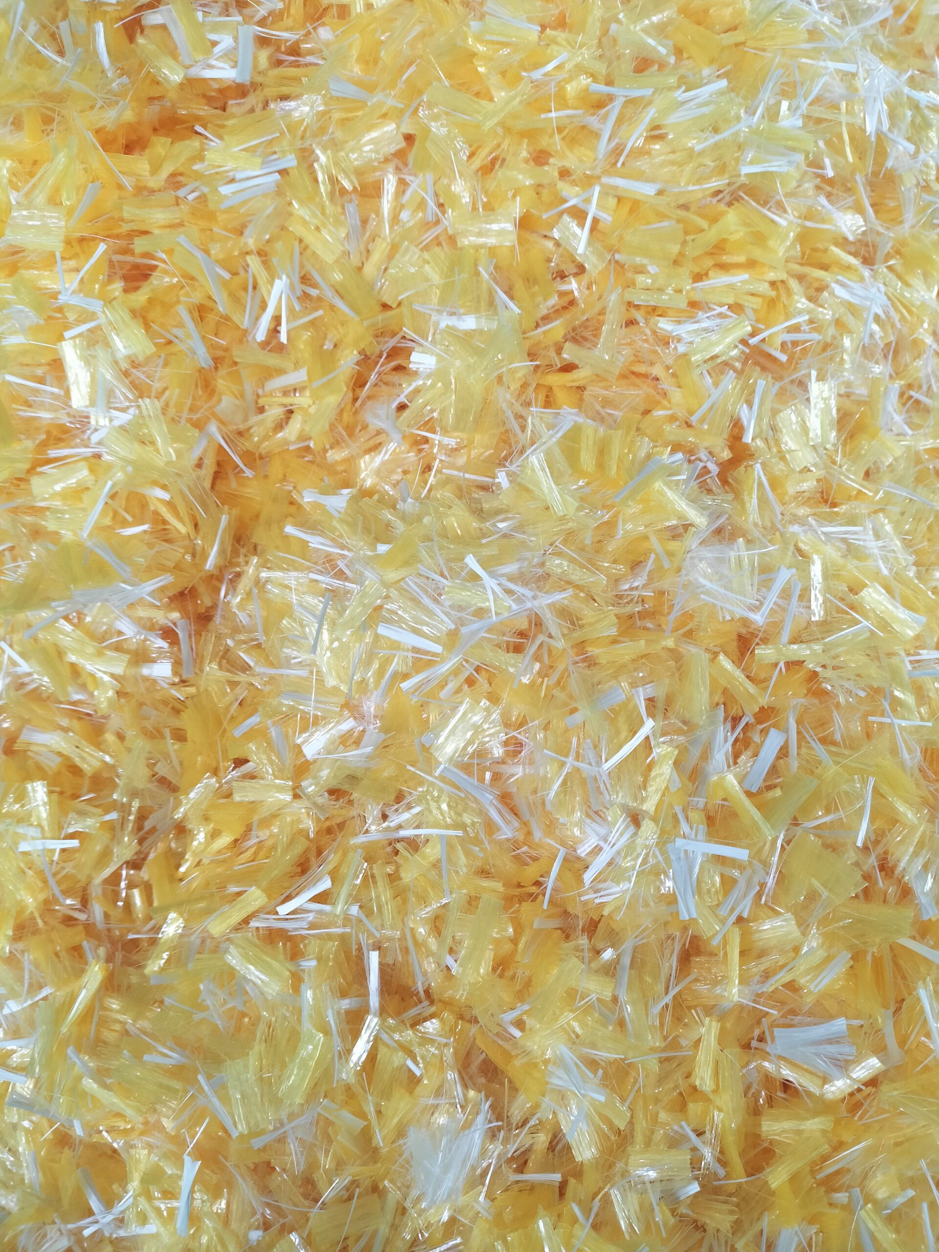 Aramid fibers being mixed into asphalt for road construction